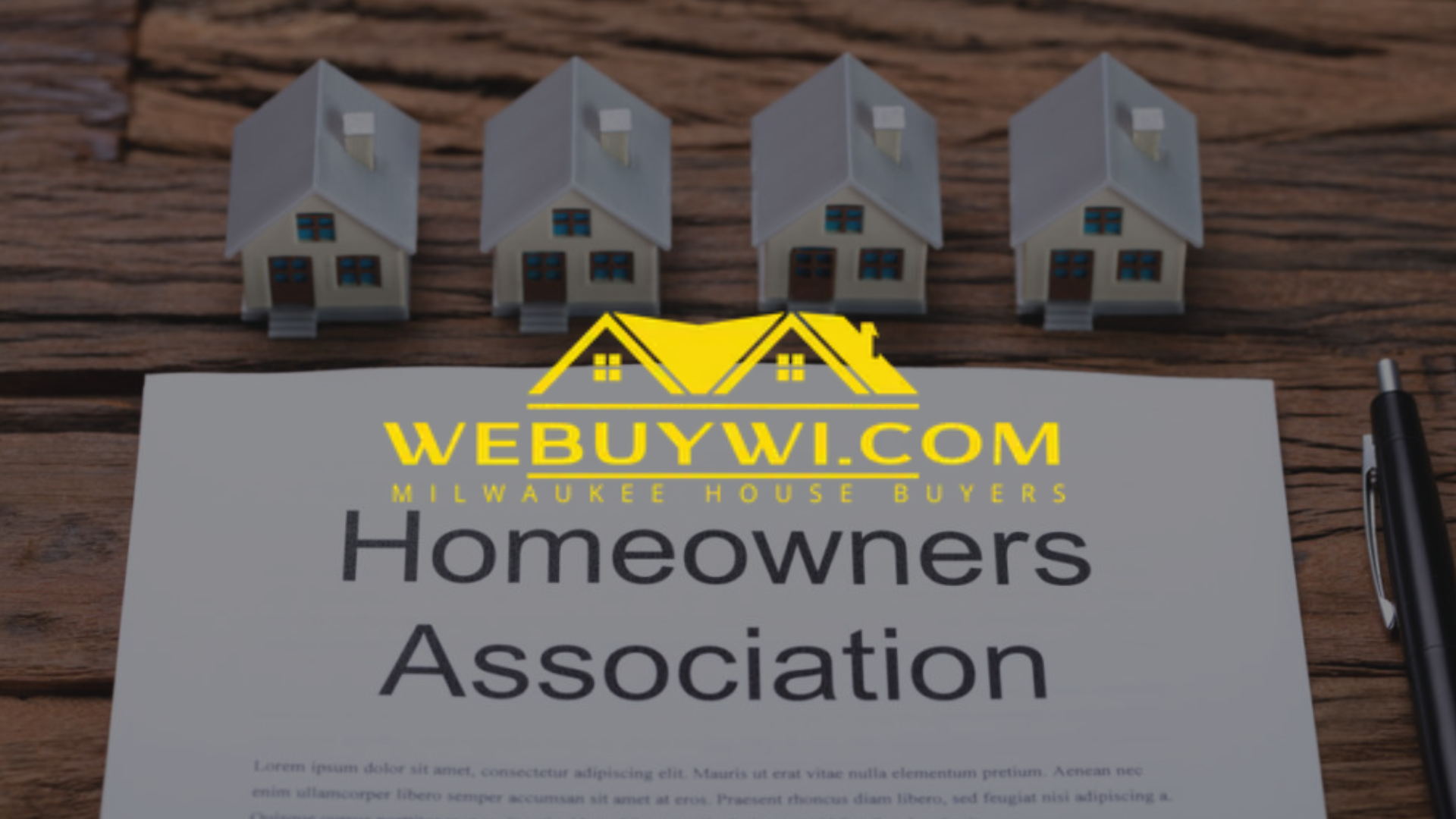 Four miniature houses above a document titled