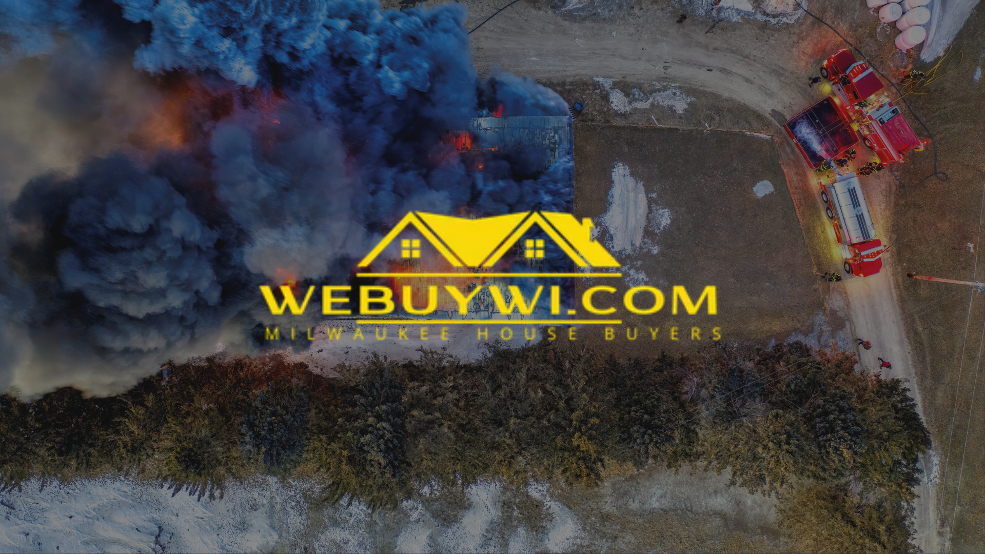 Fire engulfs structure; fire trucks on scene; dark smoke, yellow logo WEBUYWI.COM.