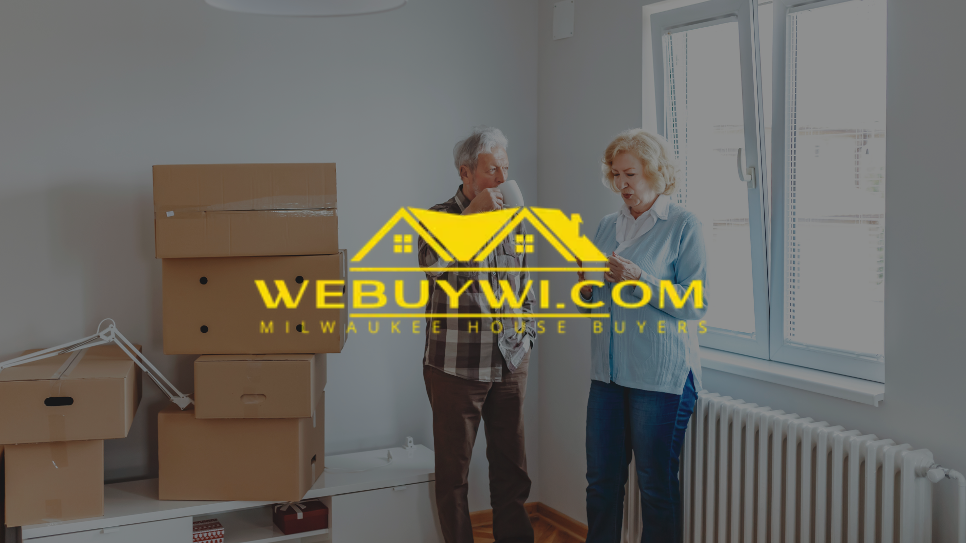 Older couple inside a room with moving boxes, looking at papers. Website logo overlayed.