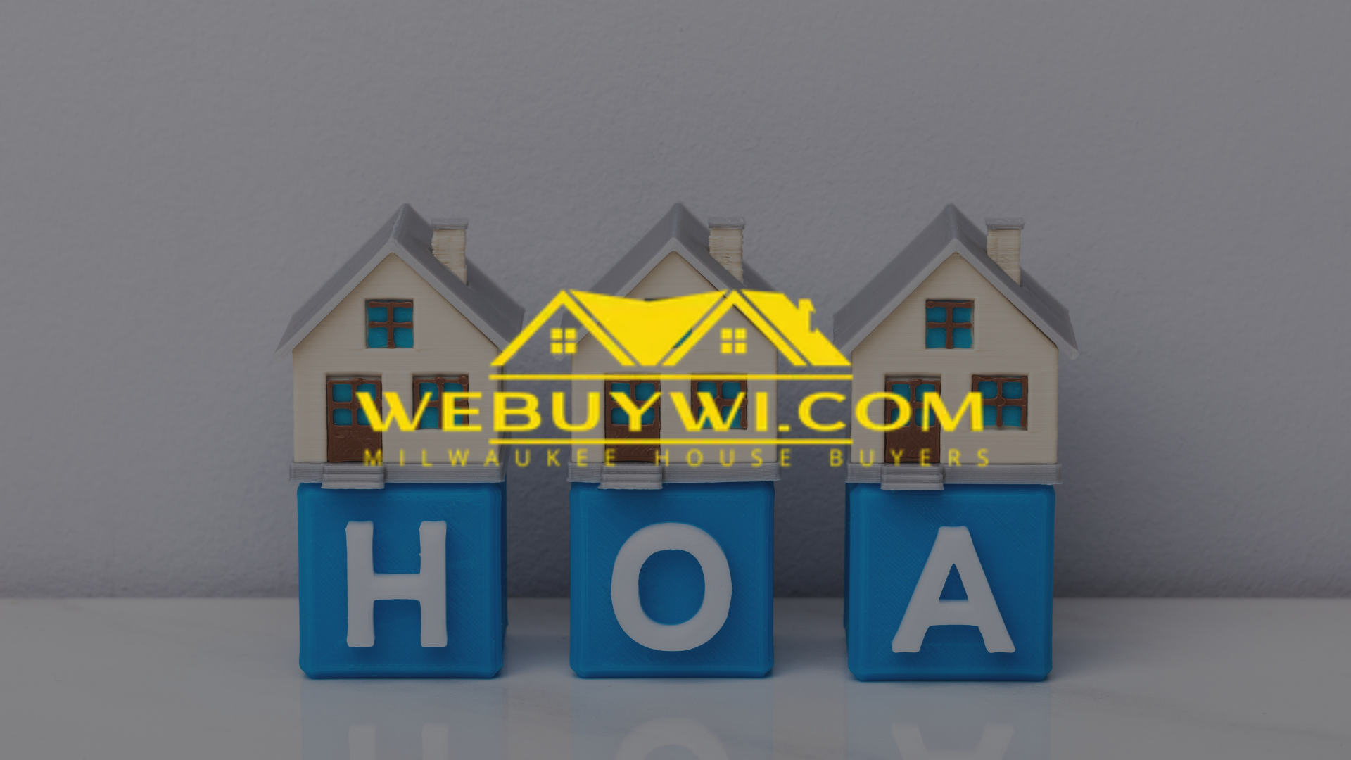 Three toy houses sit on blue blocks spelling HOA, with a website logo overlay.