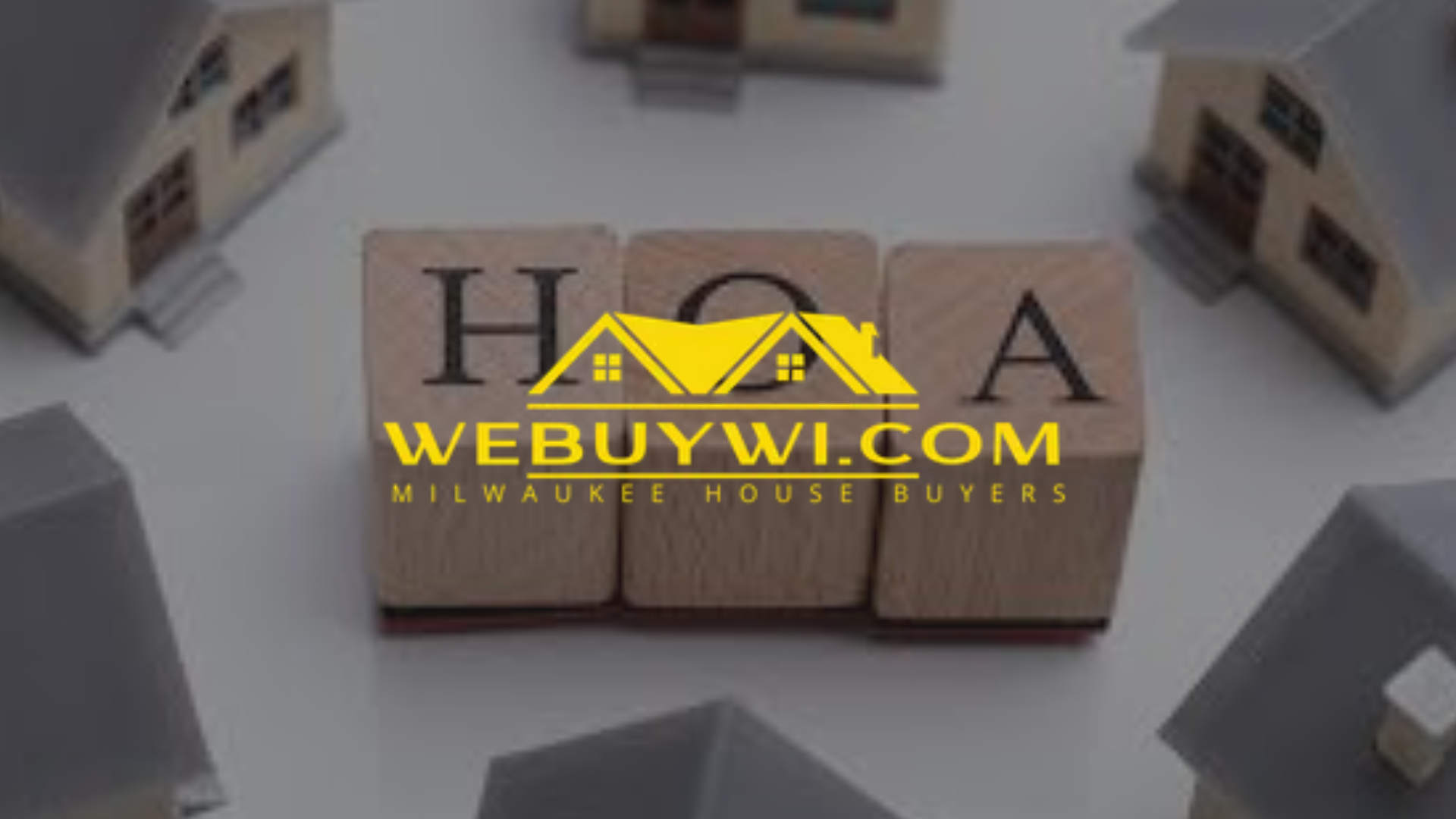 Wooden blocks spelling HOA, with a house logo, and tiny model houses.