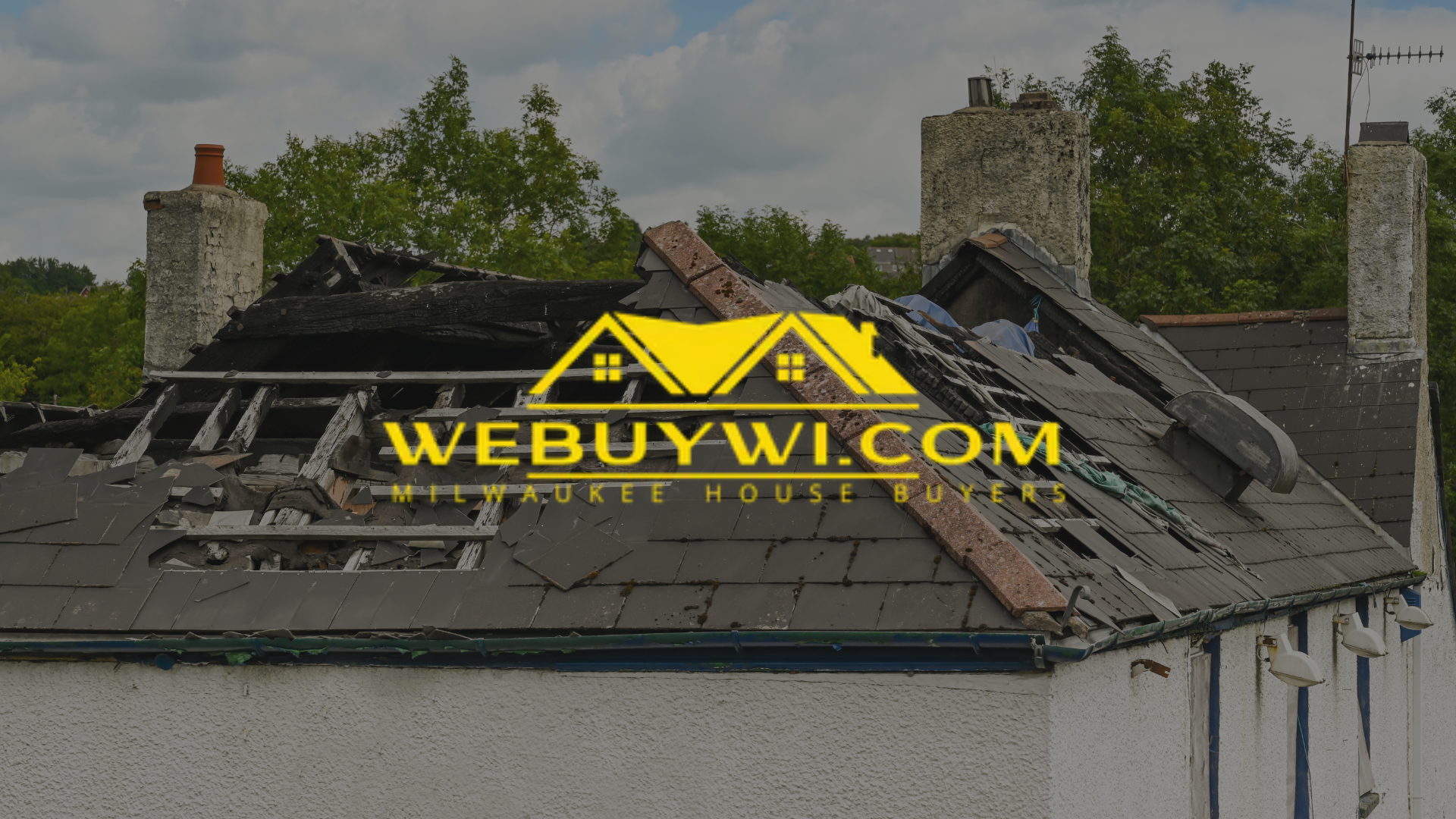 Damaged roof on a white house with a visible 