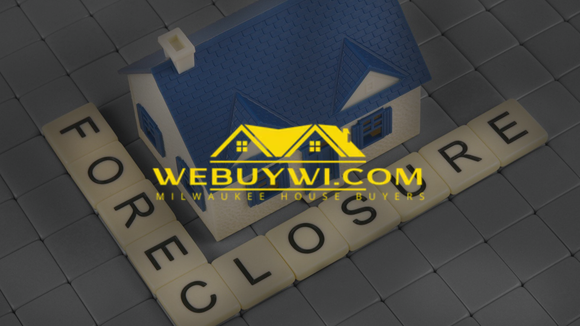 Toy house on a grid with letters spelling