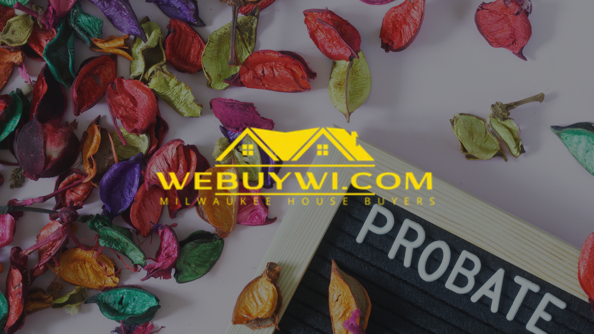 Colorful dried flowers surround a sign that reads