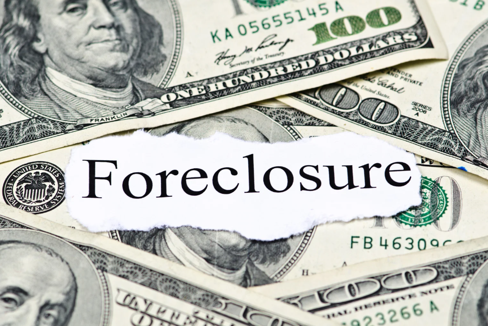 A pile of money with the word foreclosure written on it