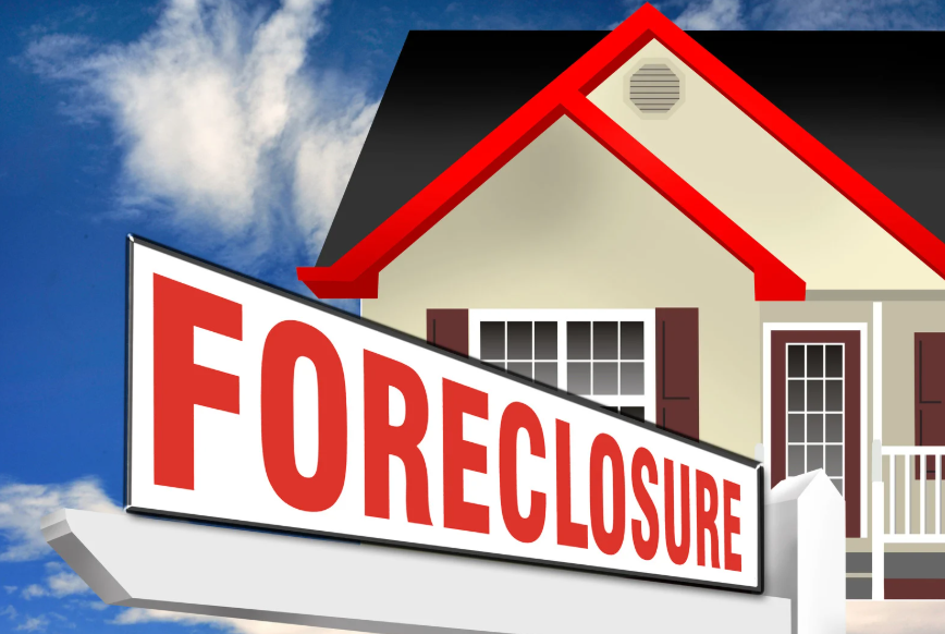 A house with a foreclosure sign in front of it