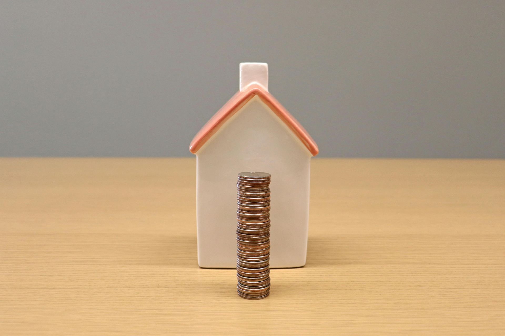 White house figurine with a stack of small brown blocks in front.