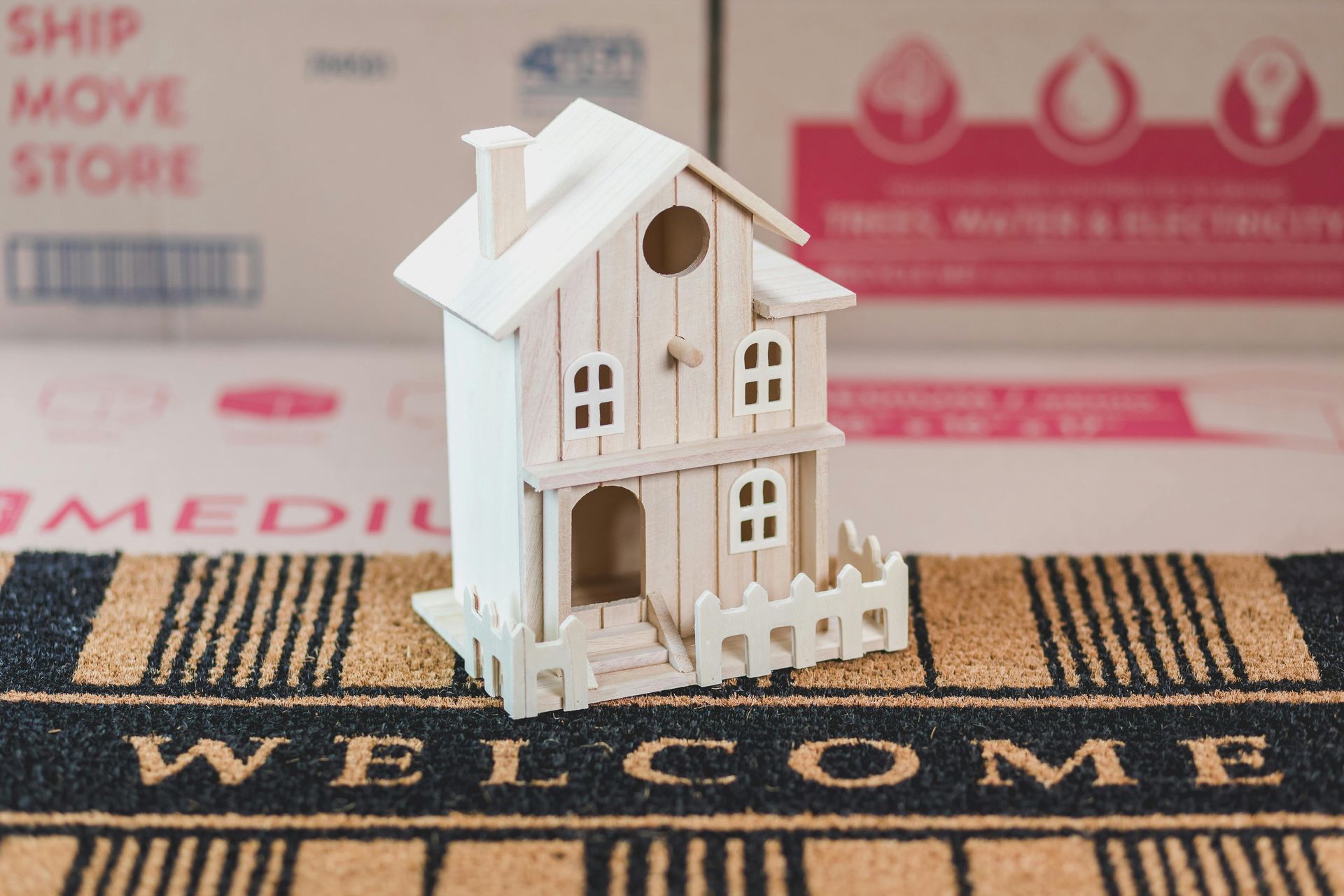 A small white wooden toy house sits on a