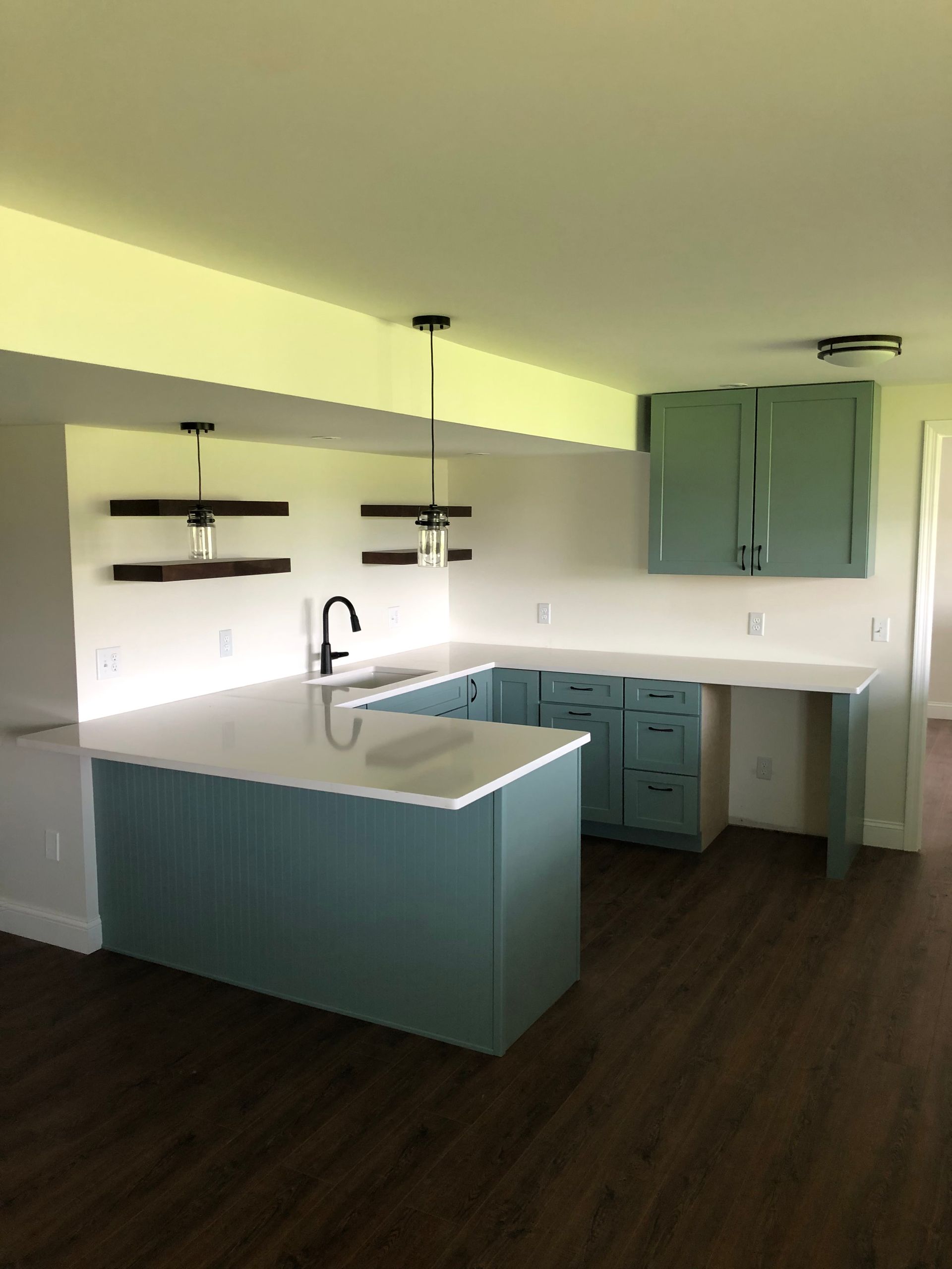 A kitchen with blue cabinets and a white counter top