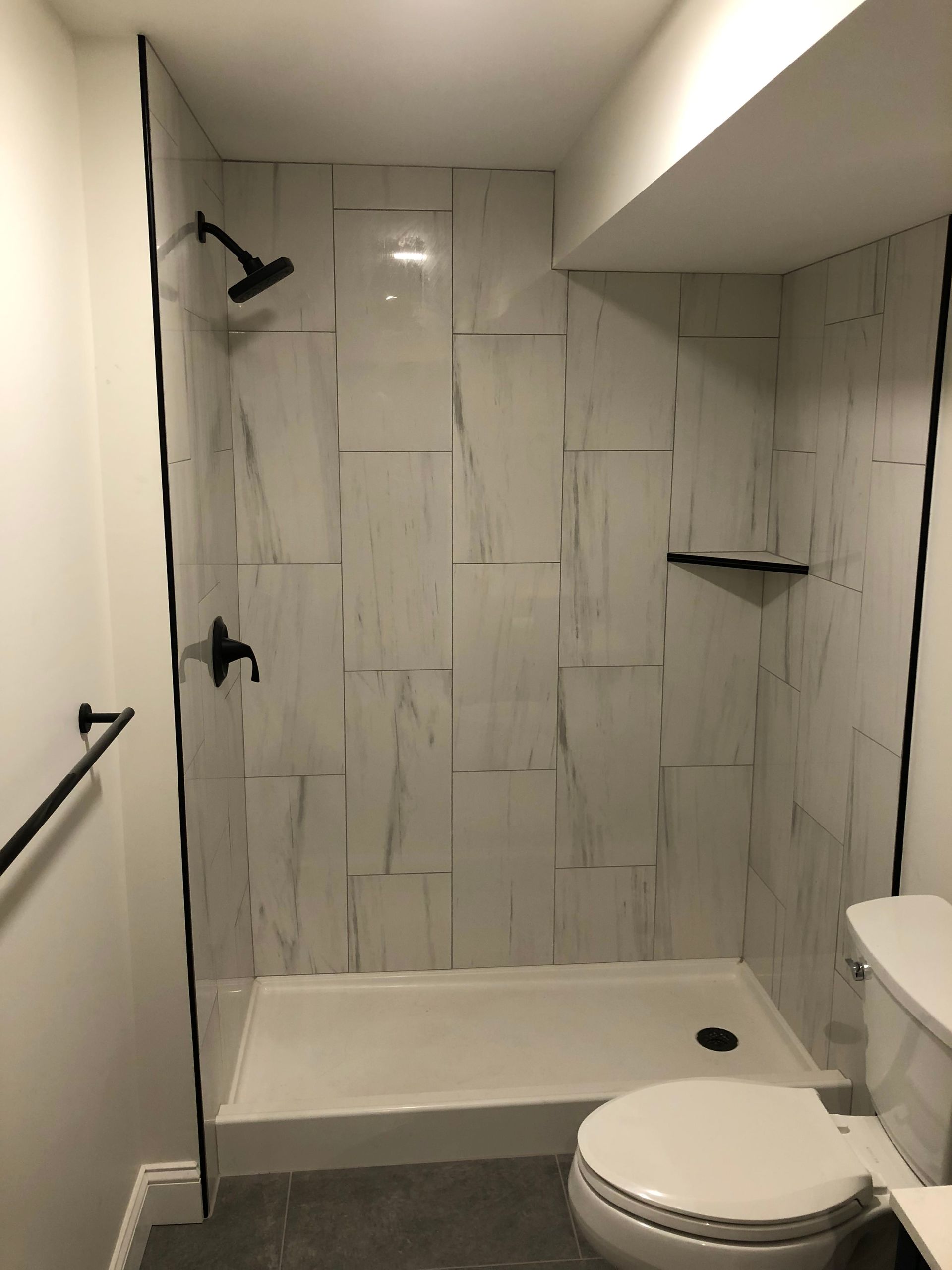 There is a toilet and a shower in the bathroom.