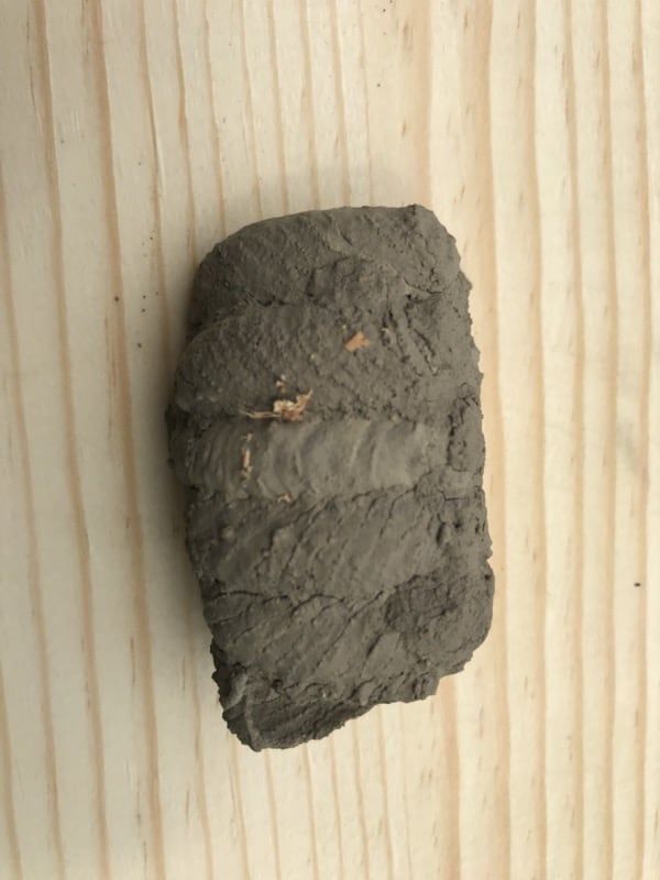 A piece of clay is sitting on a wooden table.