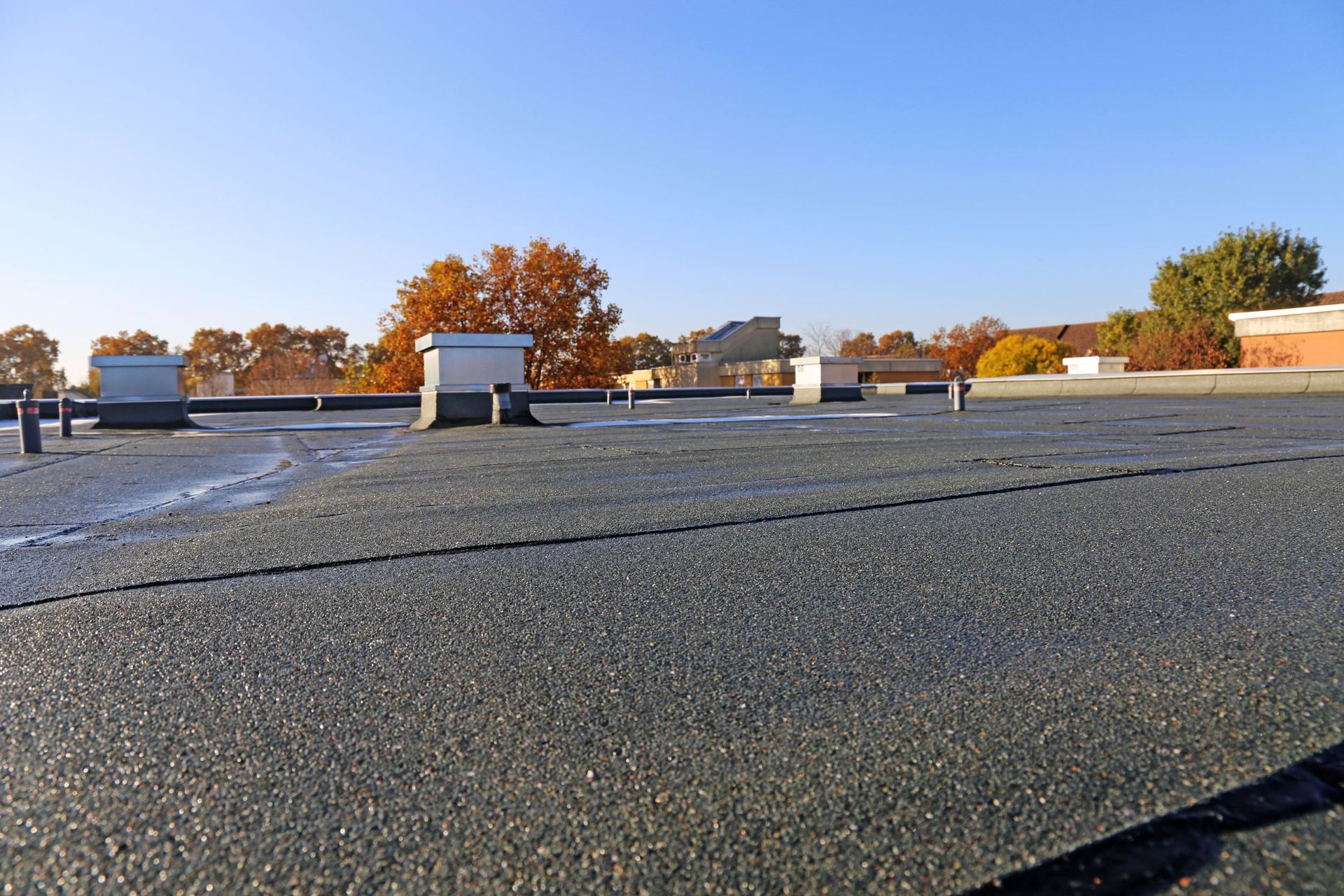 The roof of a building with a blue sky in the background