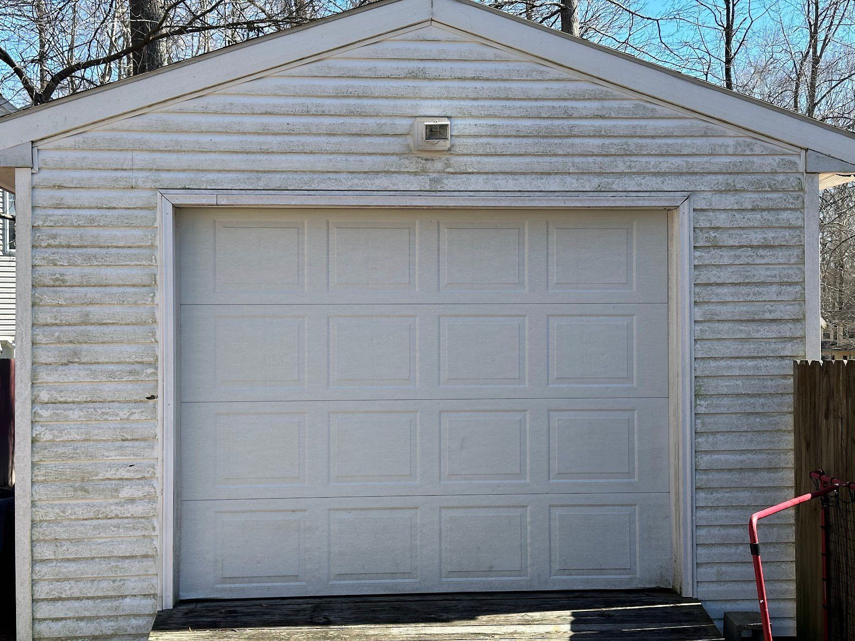 A white garage with a large white garage door