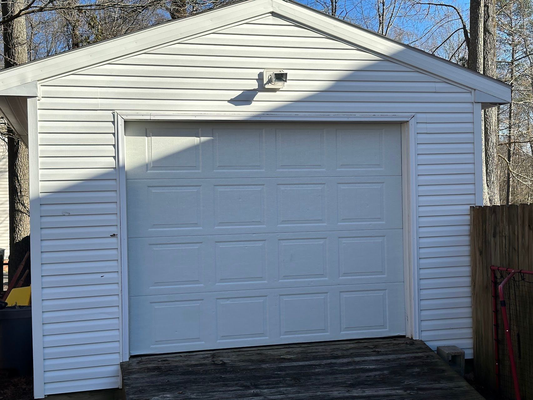 A white garage with a large white garage door