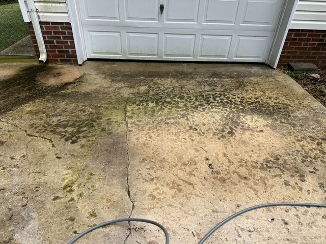 A before photo of a dirty concrete driveway pressure washing job in Gloucester, VA