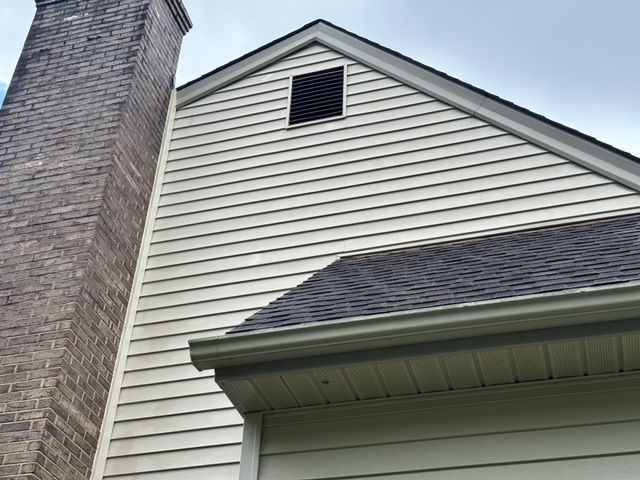 A house with a chimney on the side of it.