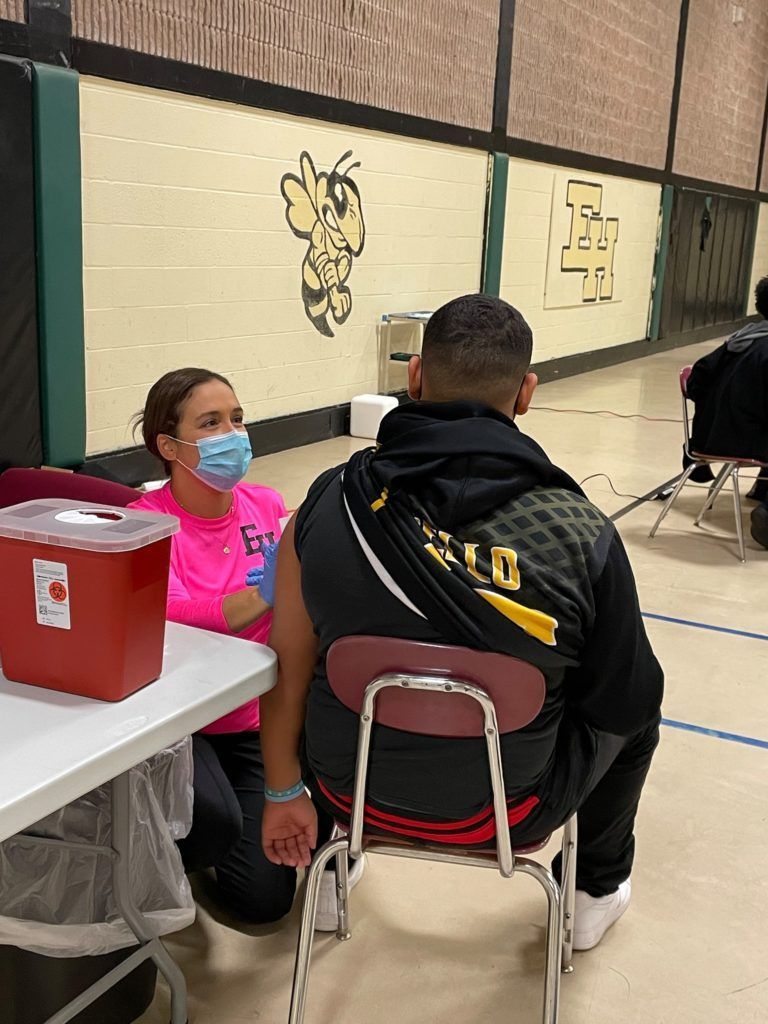 Teenager receiving COVID vaccine