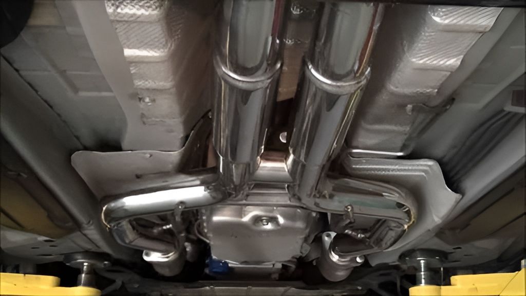 The Exhaust Pipes Of A Car Are Visible Underneath It — Tuned Suspension & Mechanic in Parkes, NSW