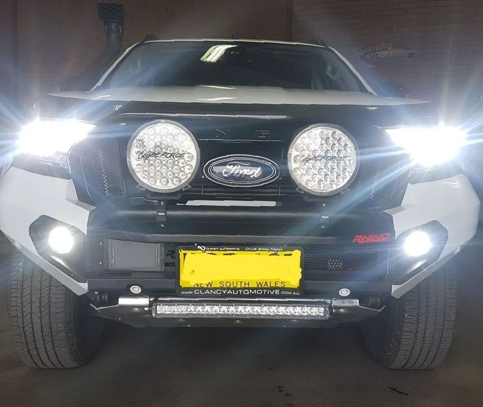 A Black And White Ford Truck Is Parked In A Garage — Tuned Suspension & Mechanic in Parkes, NSW