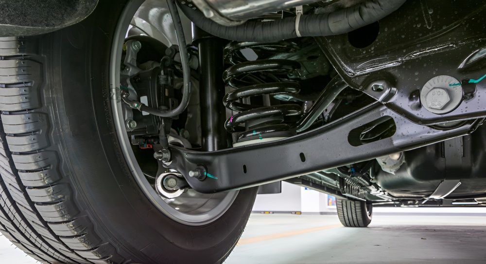 The Underside Of A Car With A Tire And Shock Absorber — Tuned Suspension & Mechanical in Parkes, NSW