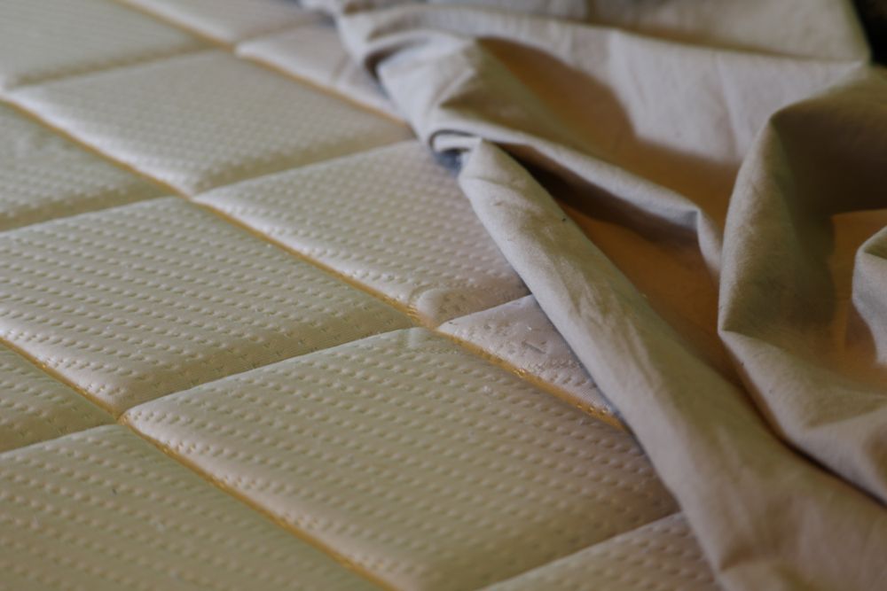 A Close Up Of A Mattress With A Piece Of Fabric On It — Allwood Upholstery In Manunda, QLD