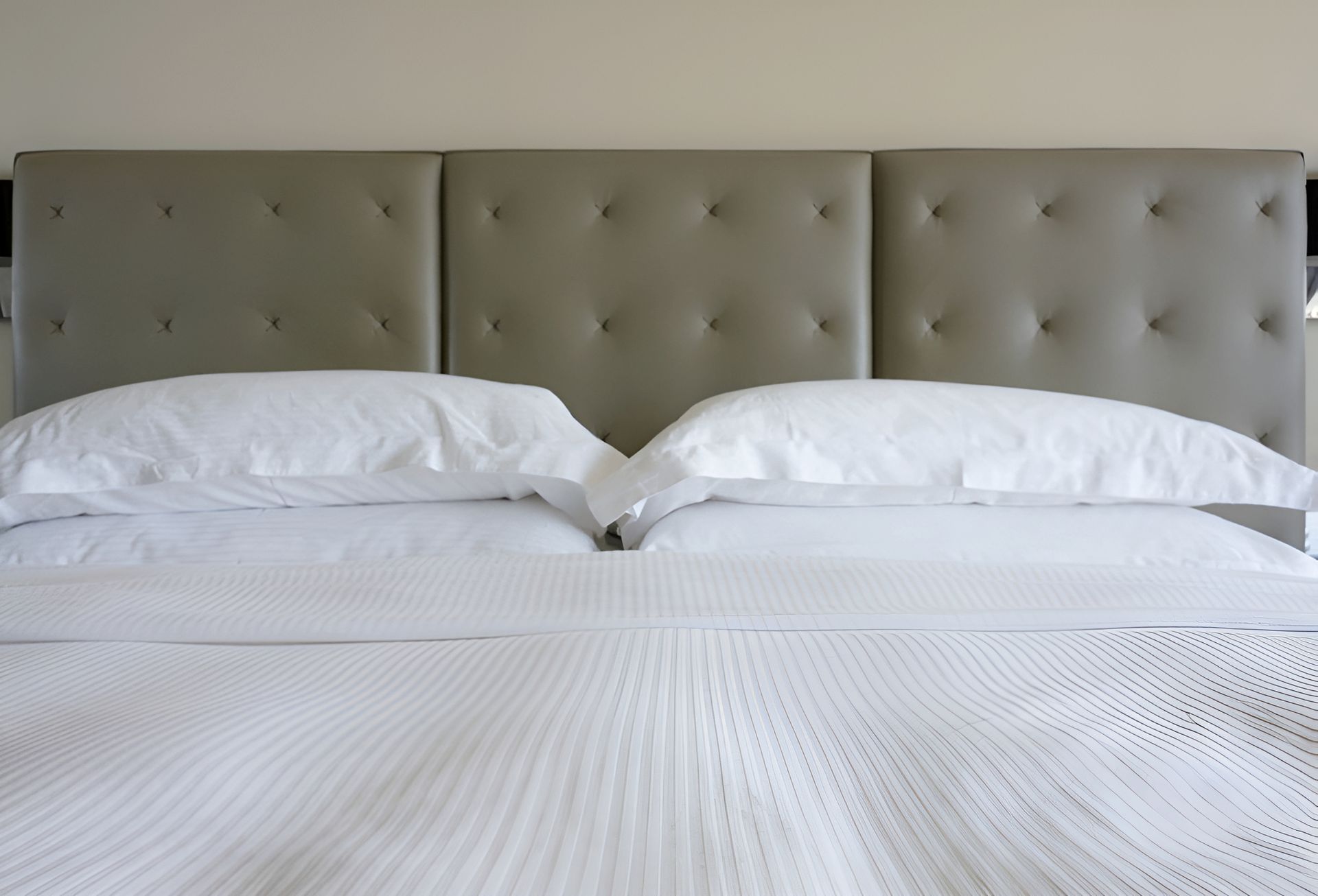 A Bed With White Sheets And Pillows And A Grey Headboard — Allwood Upholstery In Manunda, QLD