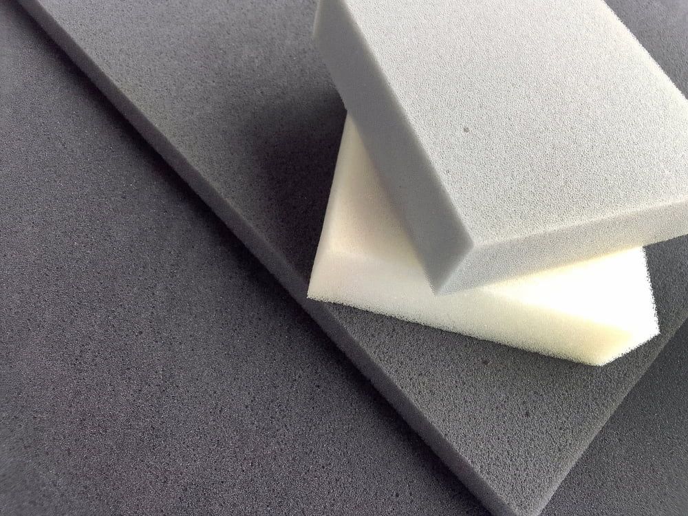 Two Pieces Of Foam Are Stacked On Top Of Each Other On A Table — Allwood Upholstery In Manunda, QLD