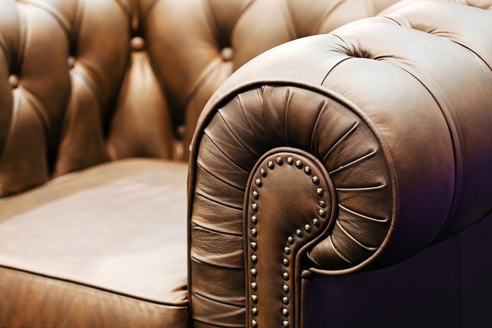 A Close Up Of The Arm Of A Brown Leather Couch — Allwood Upholstery In Manunda, QLD