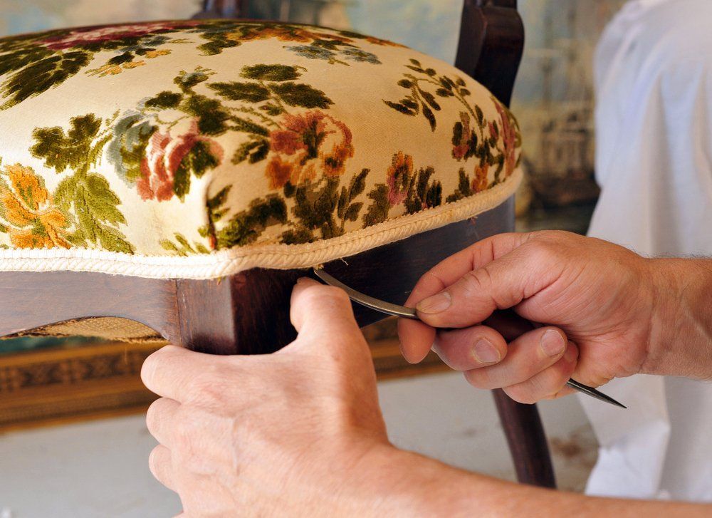 A Person Is Fixing A Chair With A Pair Of Scissors — Allwood Upholstery In Manunda, QLD
