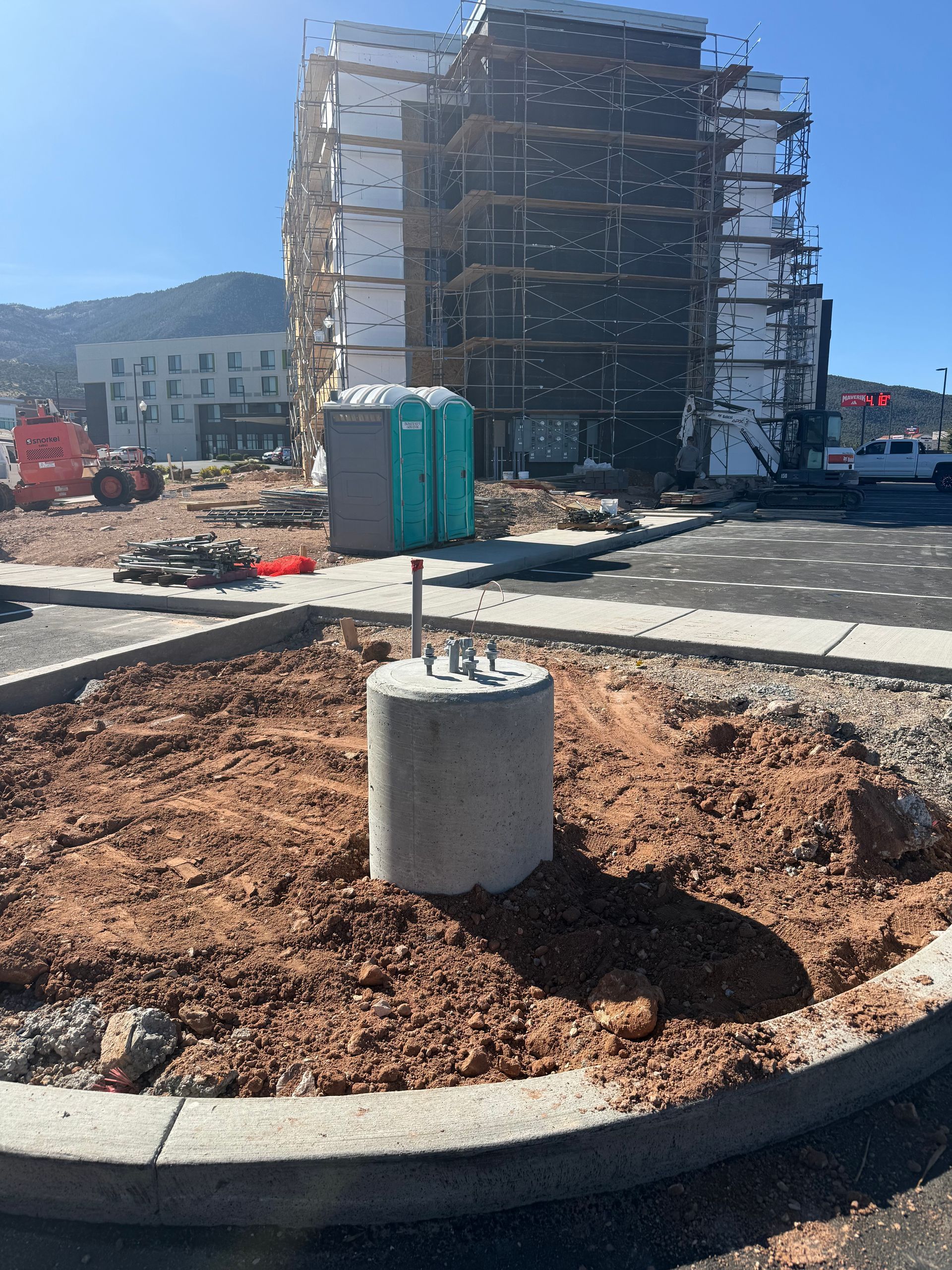 A concrete base with a metal post on top of it