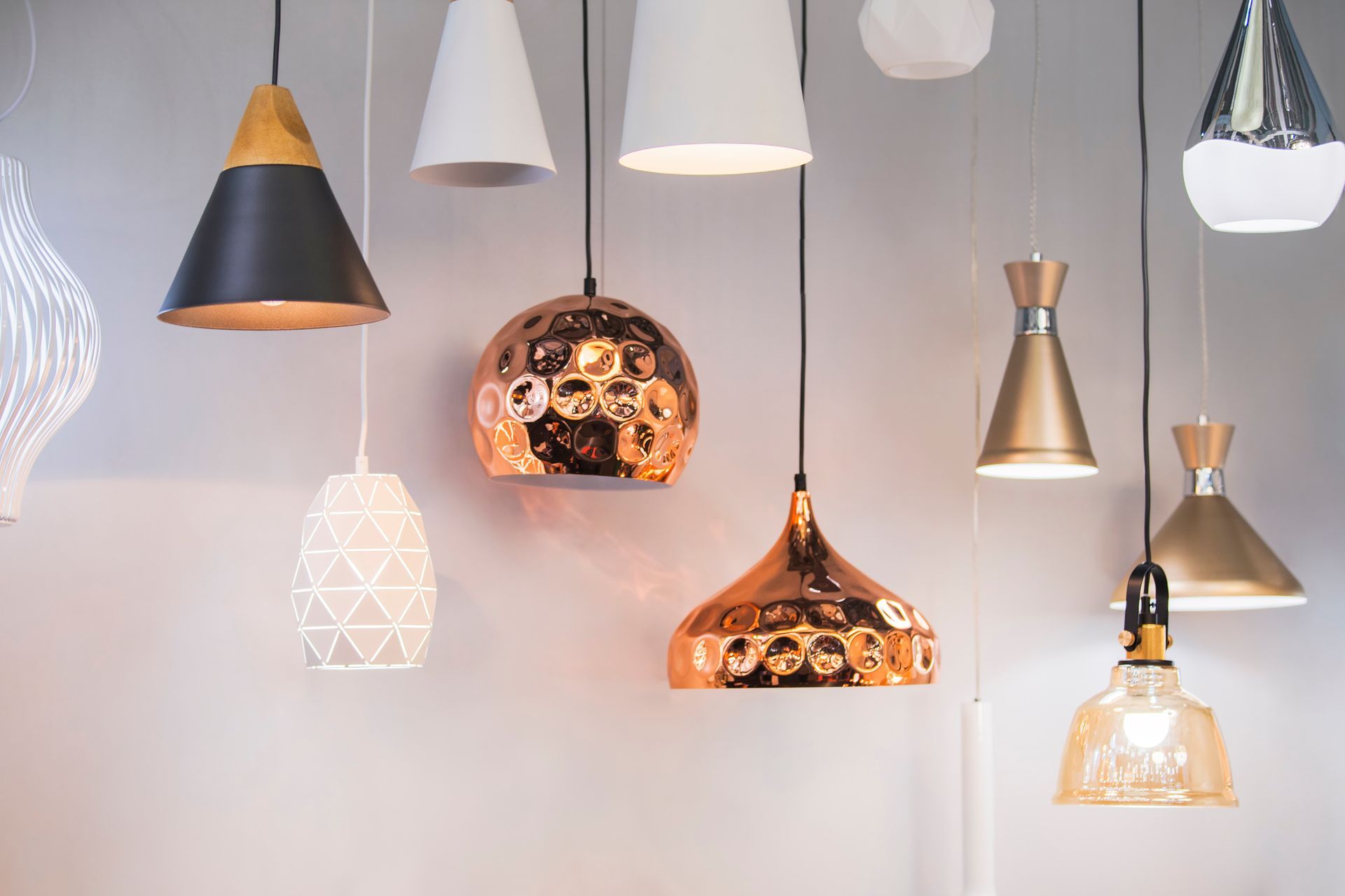 A row of recessed lights are lined up on a ceiling.
