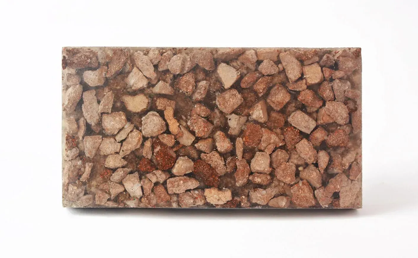 Primer plano de una losa de piedra rectangular con un patrón de rocas moteadas en tonos marrones y tostados.