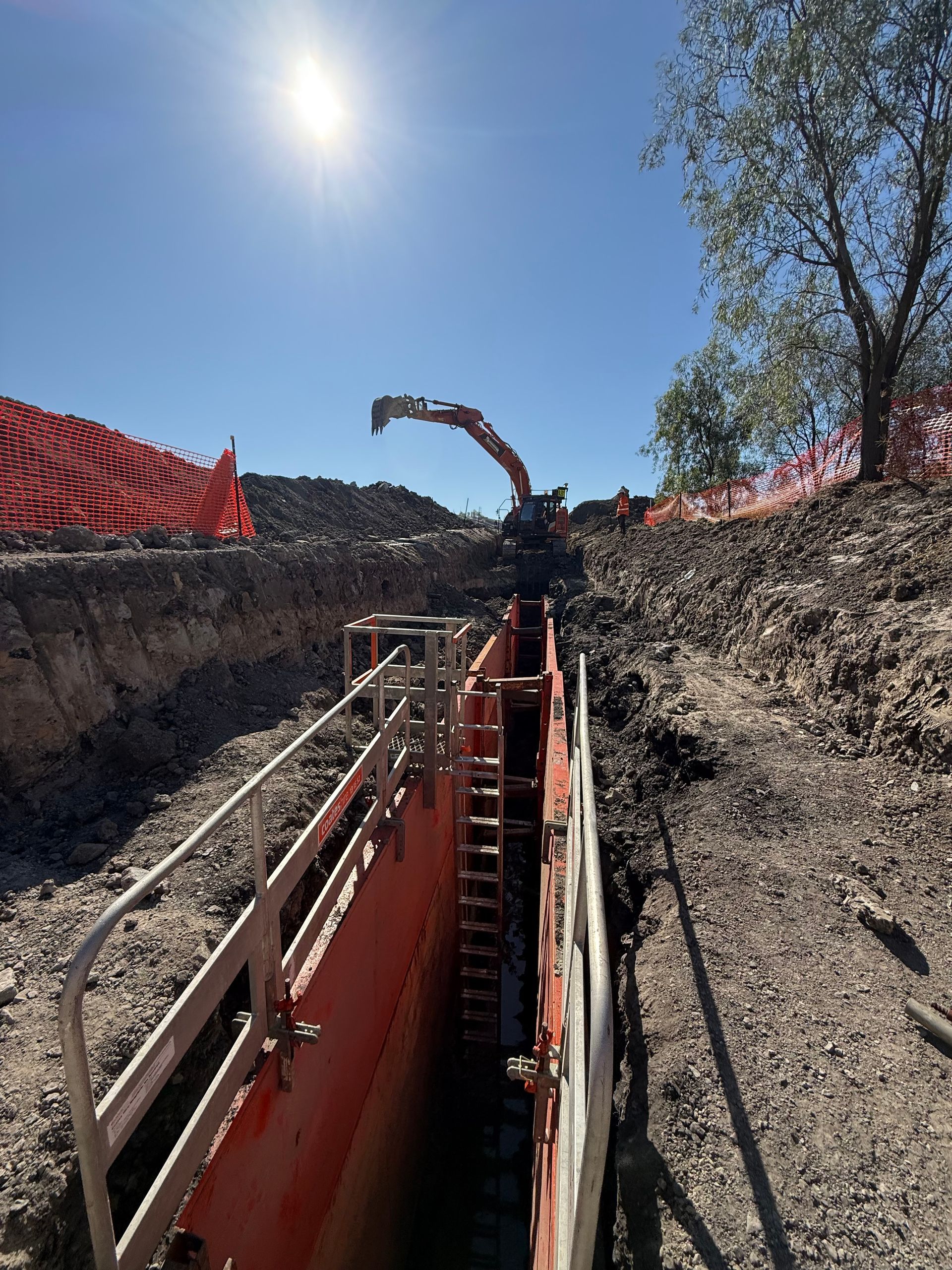 excavator digging long trench