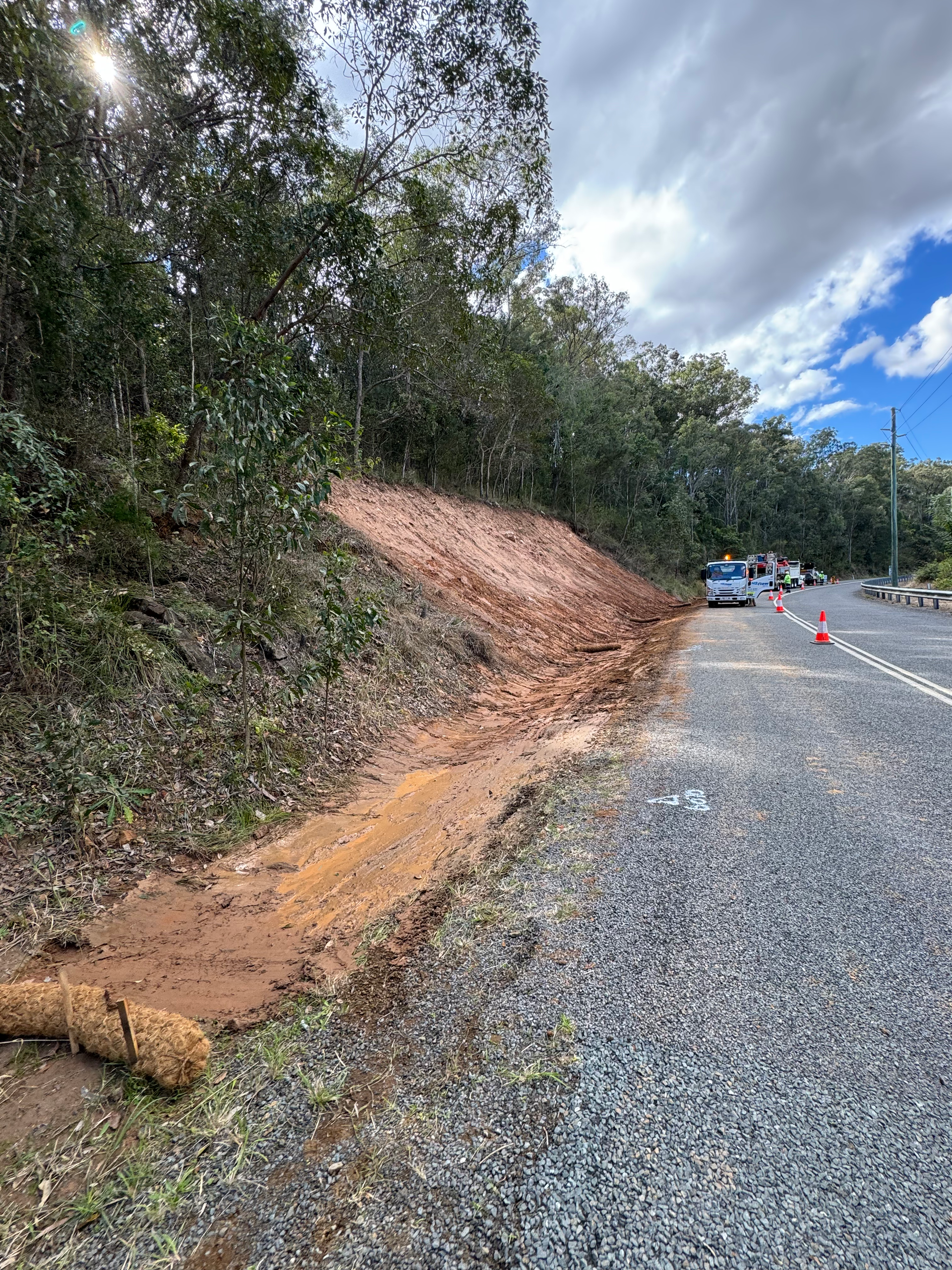A work in progress photo of repairs being made to a hillside damaged by erosion.