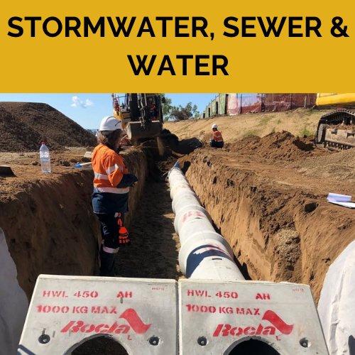 A man is standing in a trench next to a large stormwater pipe.