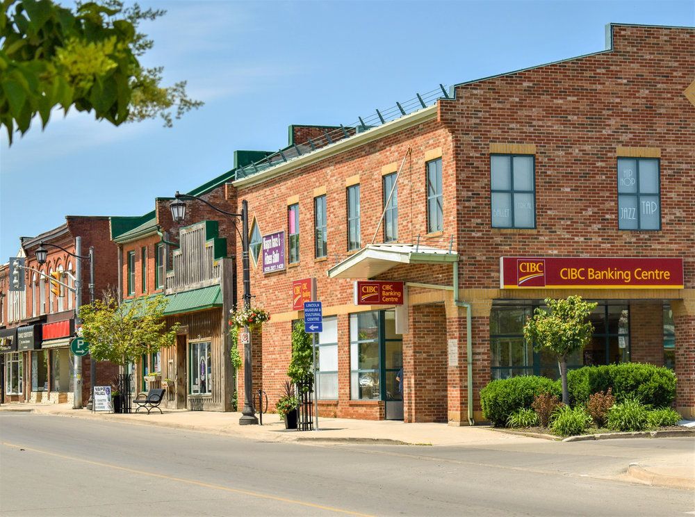 A row of brick buildings with a cbc banking center in the middle