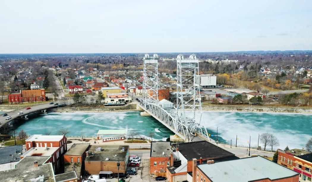 An aerial view of a city with a bridge over a river.