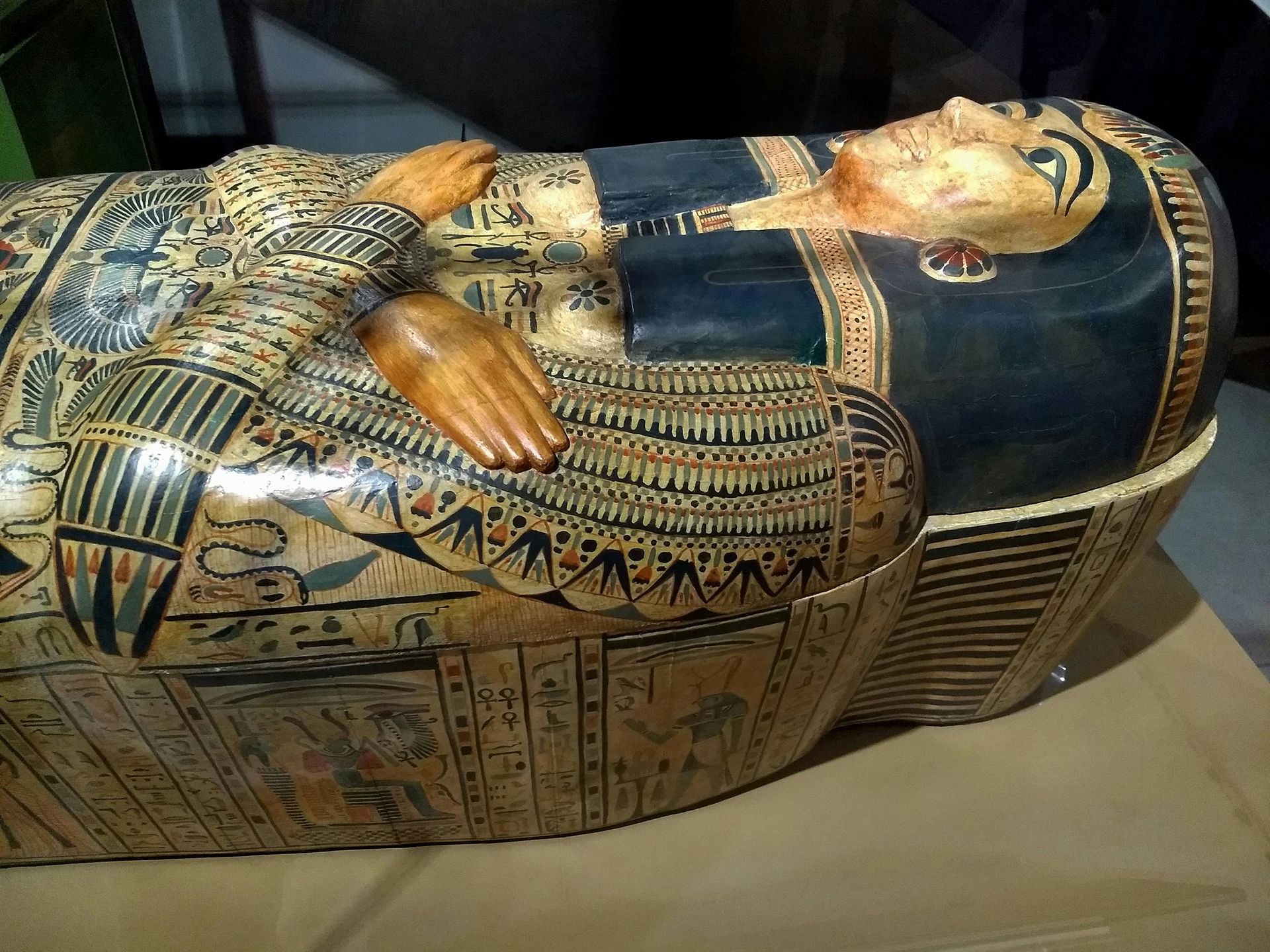 Egyptian sarcophagus with detailed hieroglyphs and painted face.