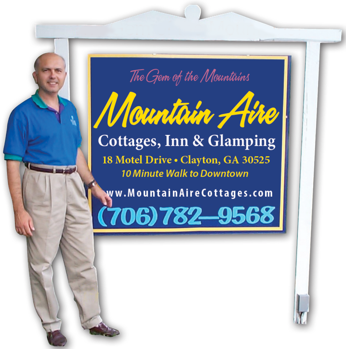 Man Standing Next to a Street Sign