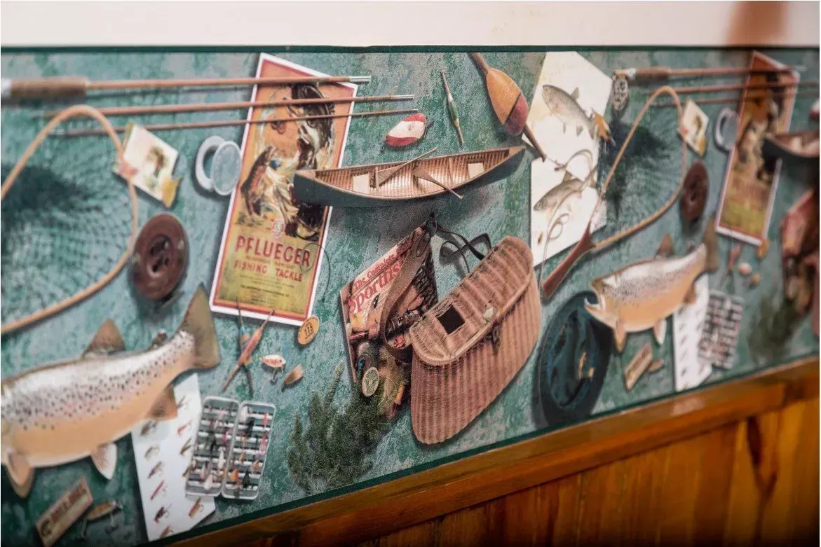 Fishing-themed wallpaper border with fish, gear, and a small wooden boat.