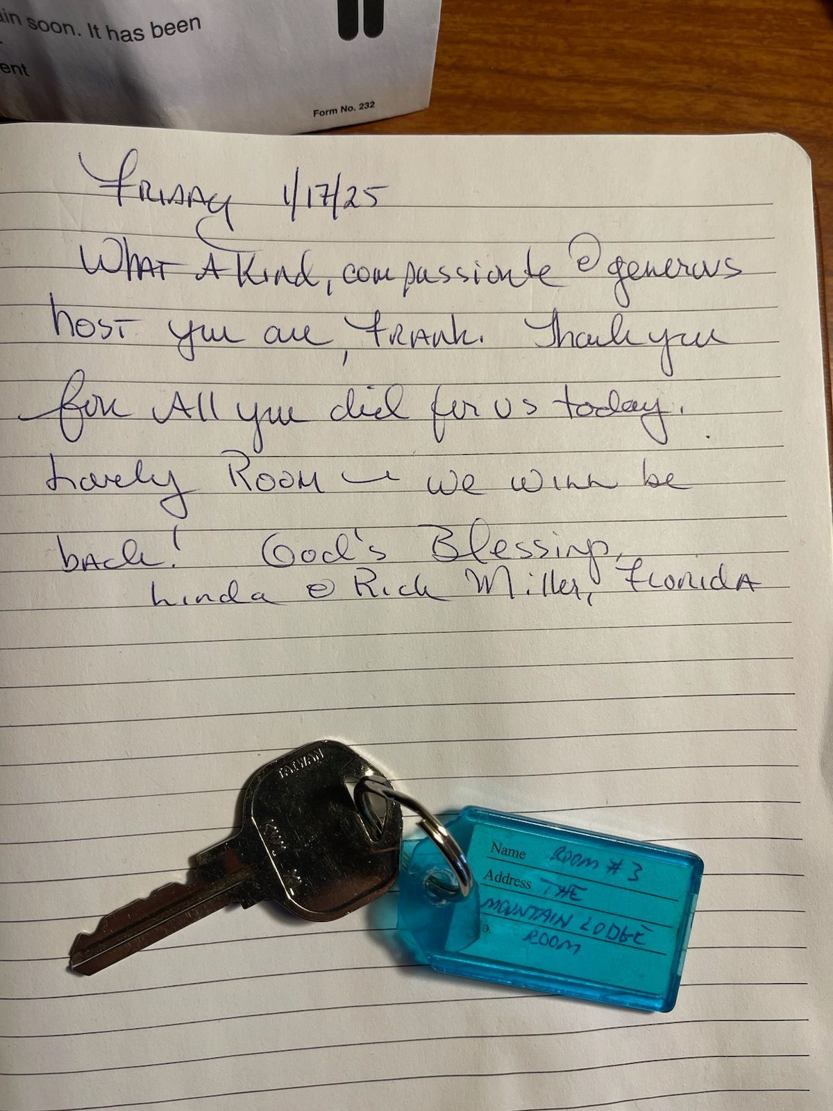 Handwritten note with a key on a notepad, thanking someone for being a kind and gracious host.