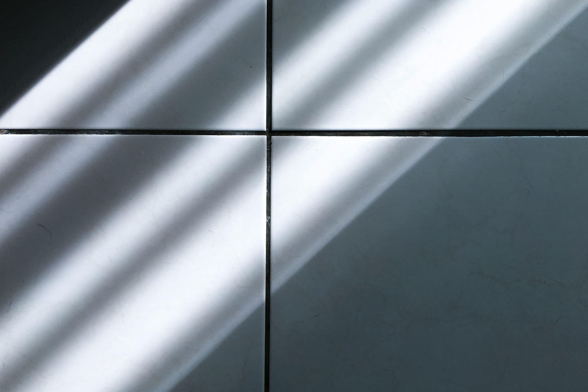 Light and shadow pattern on square tiles.