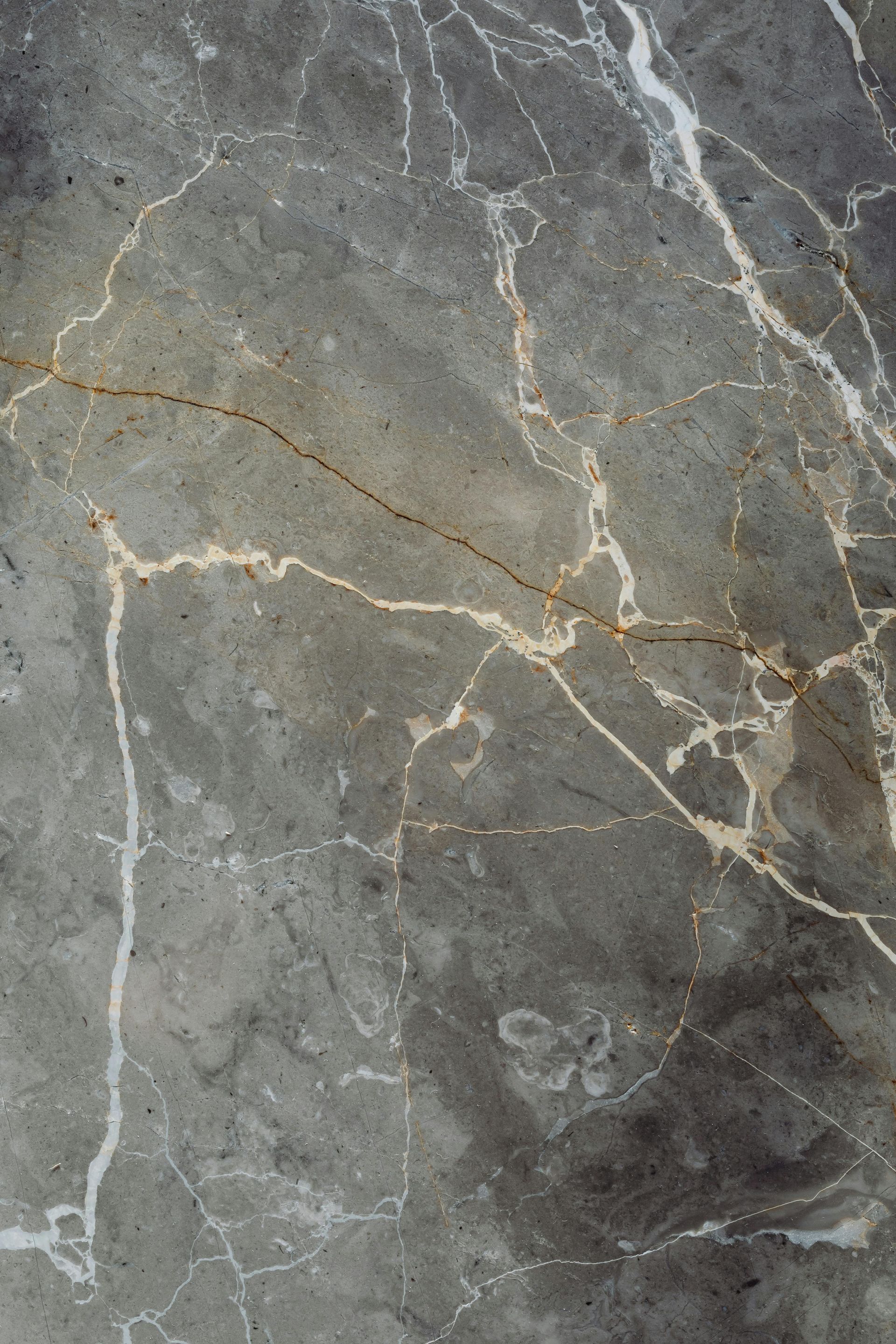 Gray marble with white and gold veining.