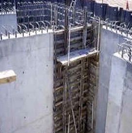 Concrete construction shaft with rebar and formwork at the top, viewed from above