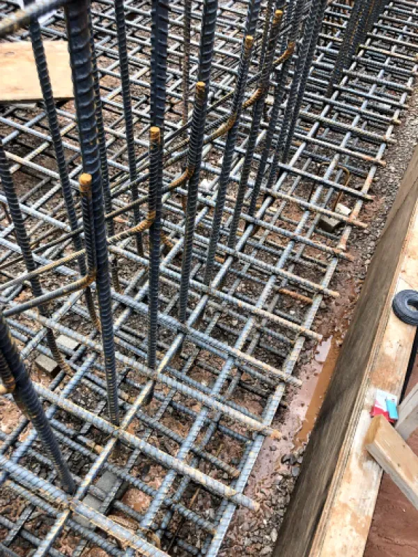 Reinforced steel bars forming a grid framework for concrete construction.
