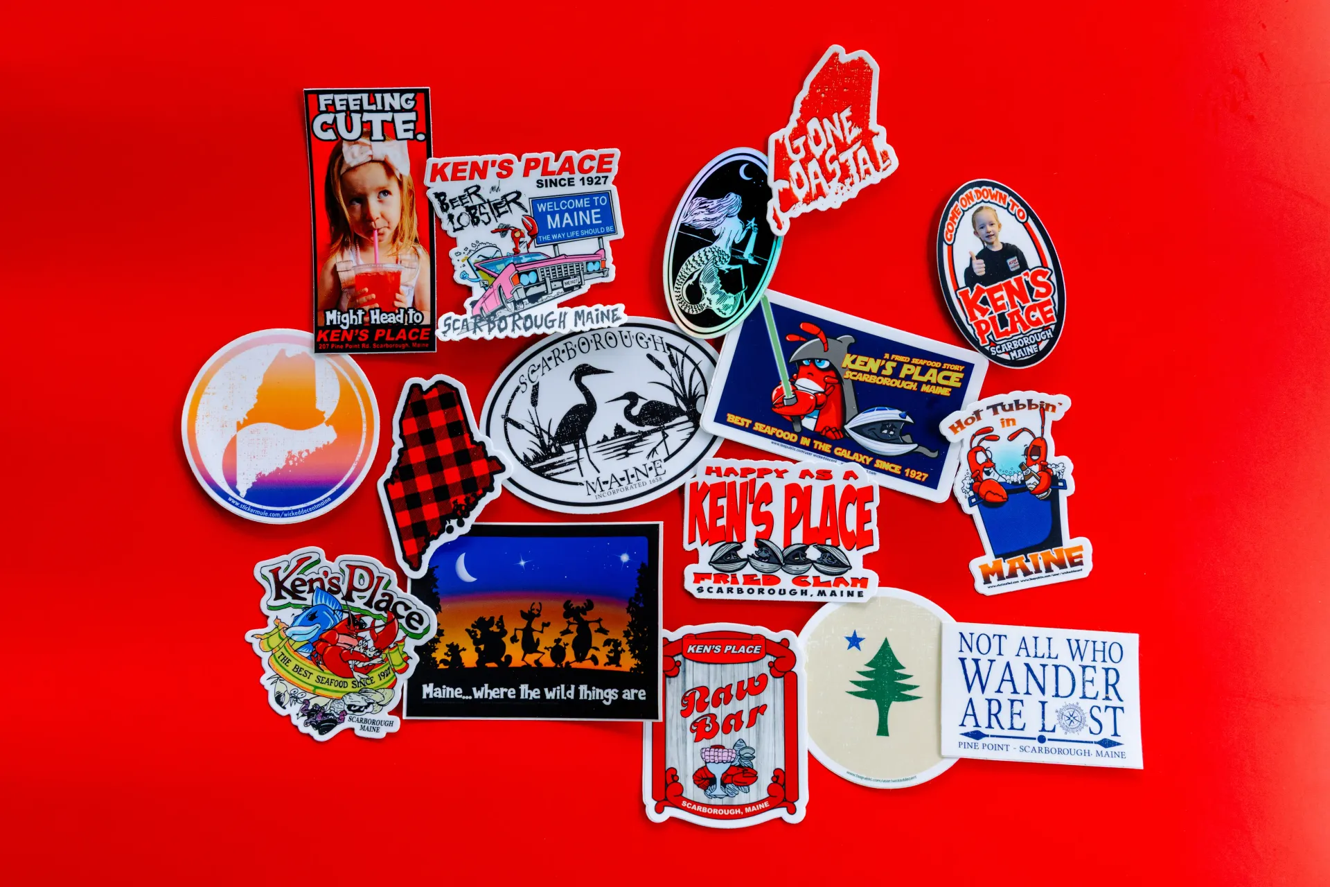 Assorted colorful stickers arranged on a bright red background