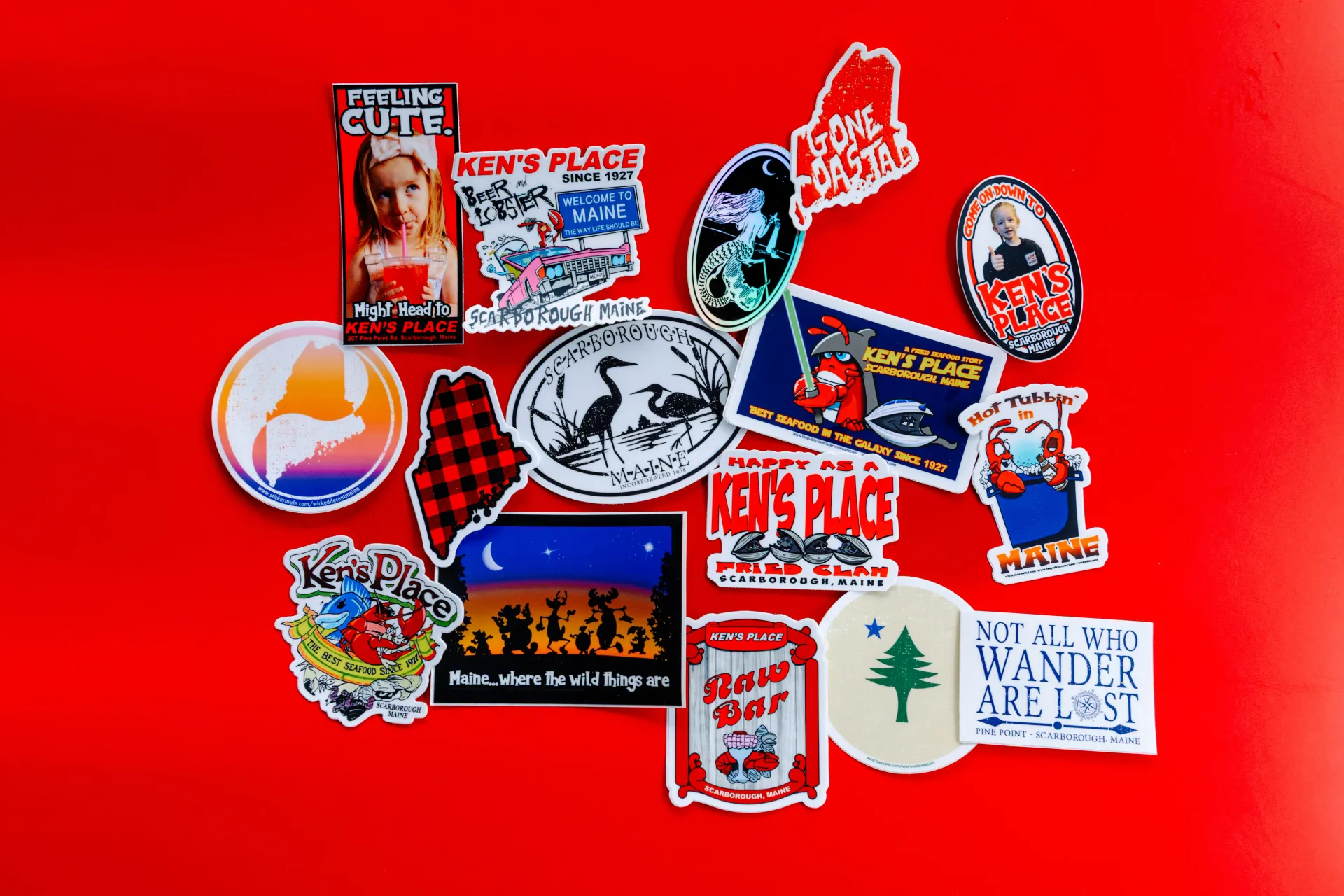 Assorted colorful stickers arranged on a bright red background