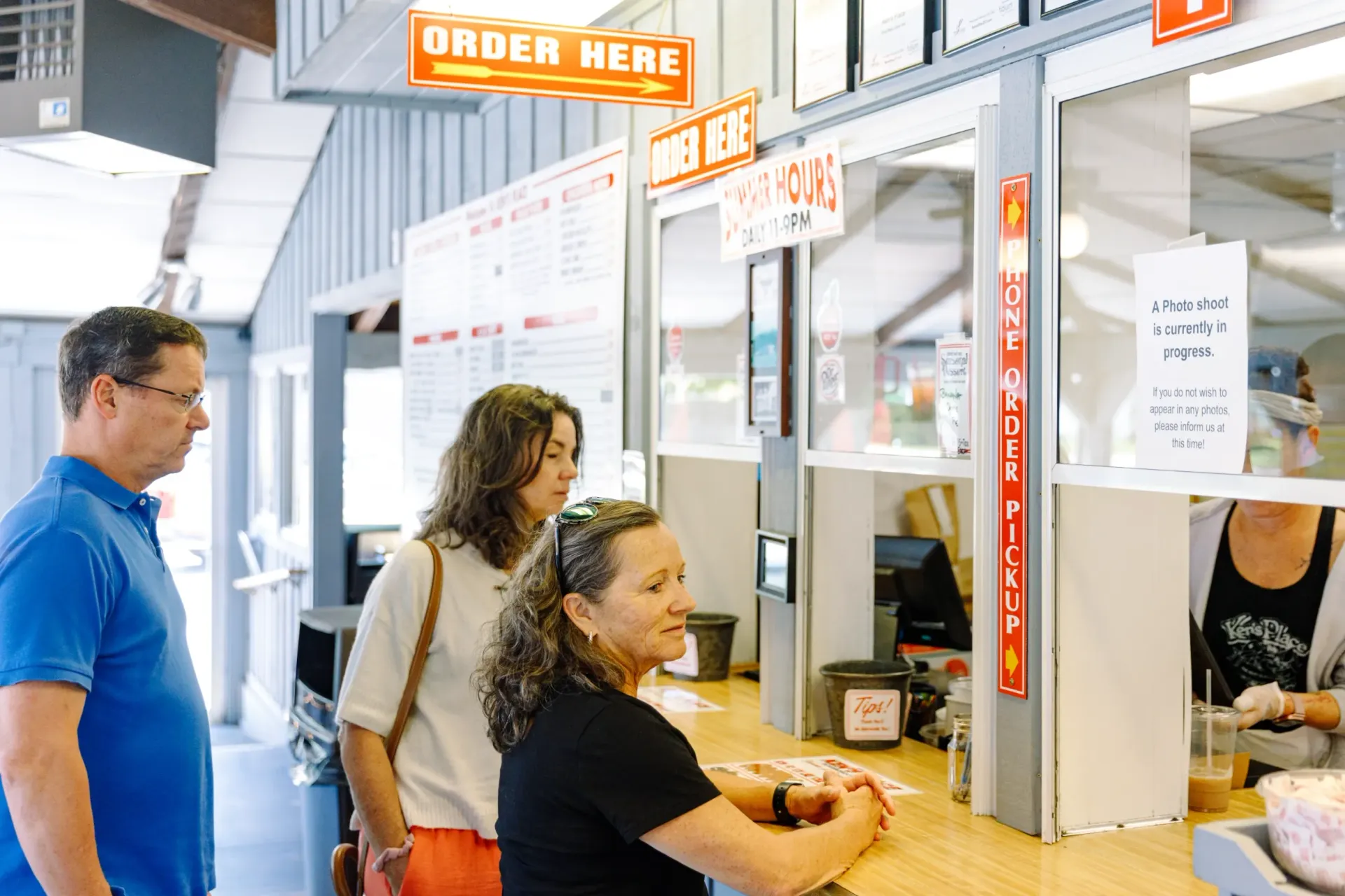 Two ladies ordering at the take out window at Ken's Seafood