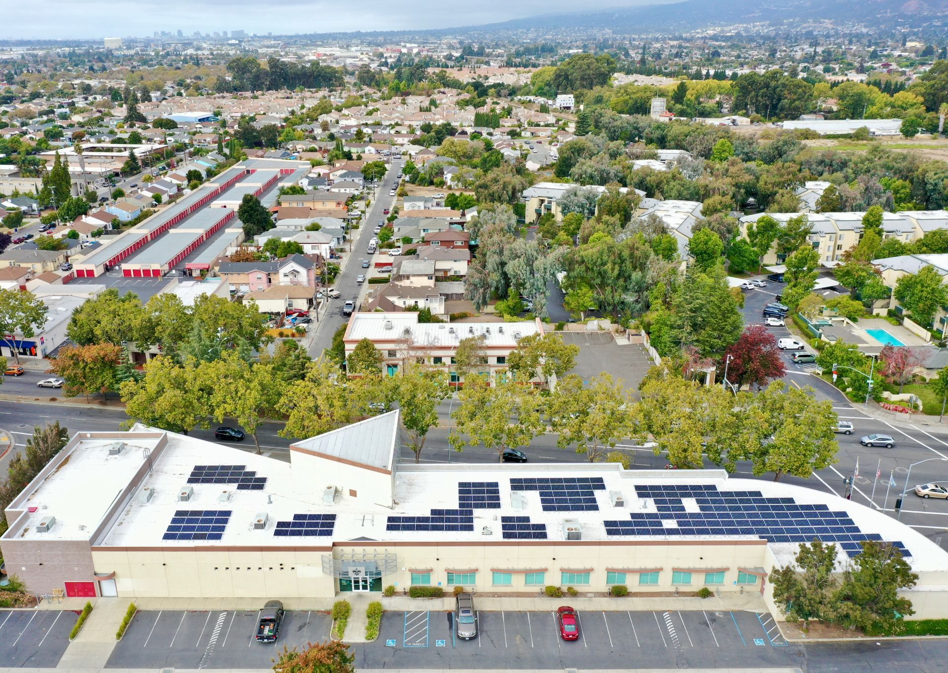 An aerial view of a building with solar panels on the roof.