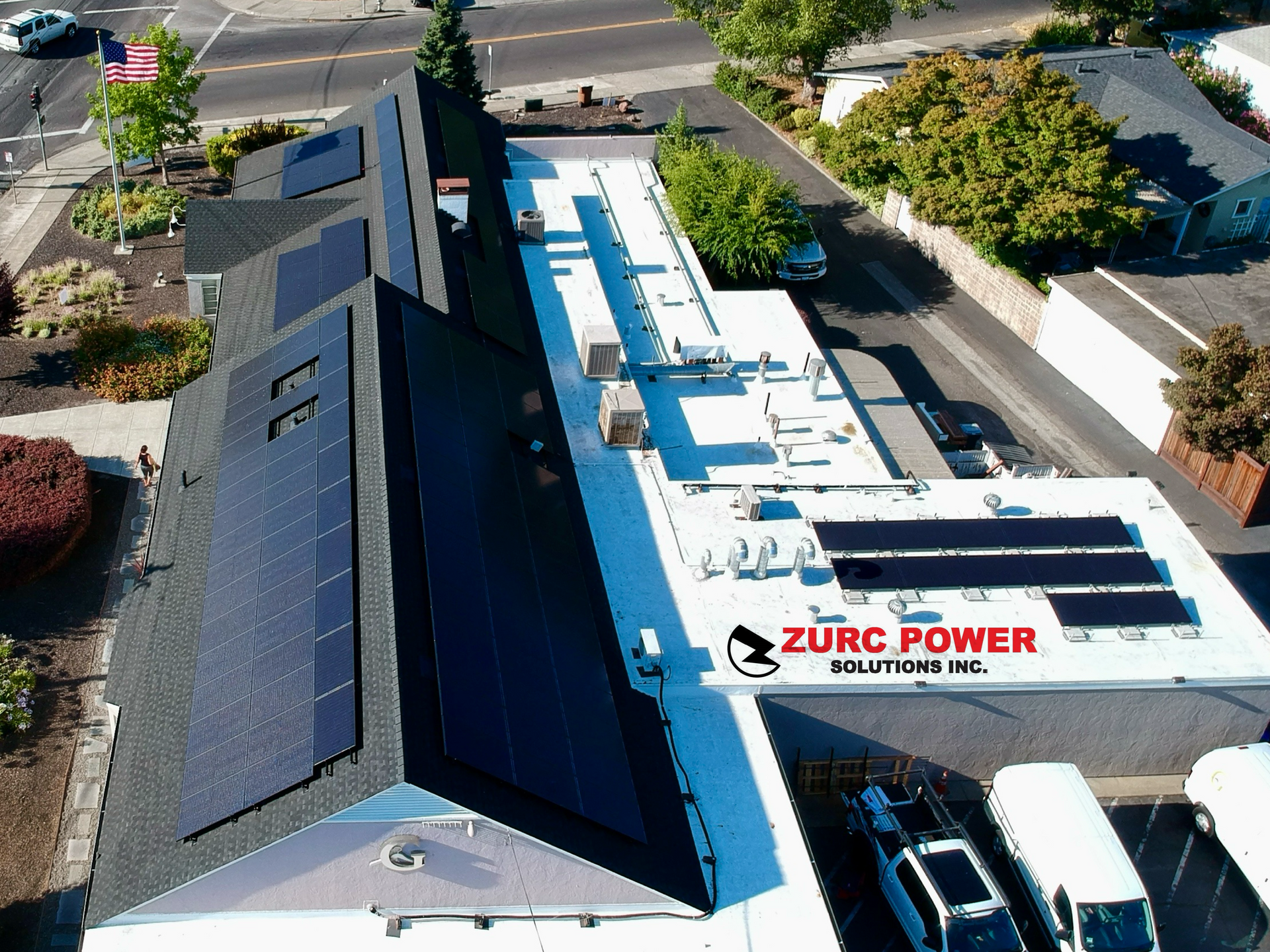 An aerial view of a building with solar panels on the roof